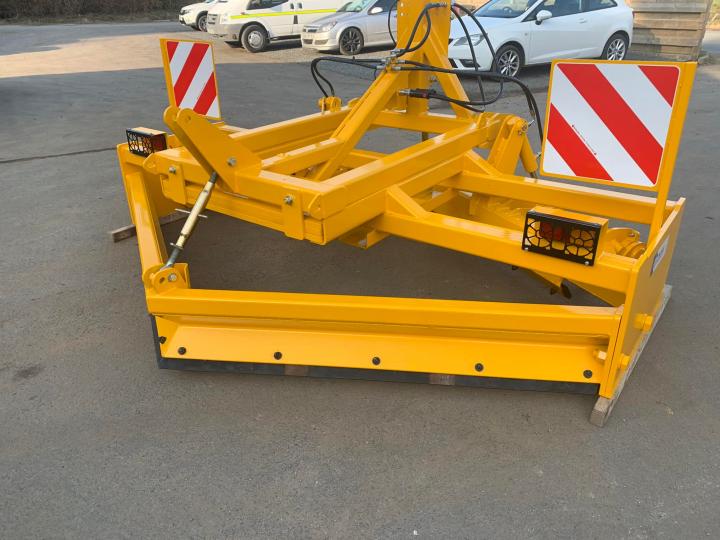 Gravel road grader with rear lights and marker boards