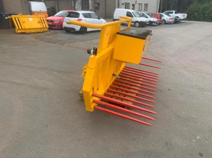 Hydraulic tipping stone fork with tool/weight box