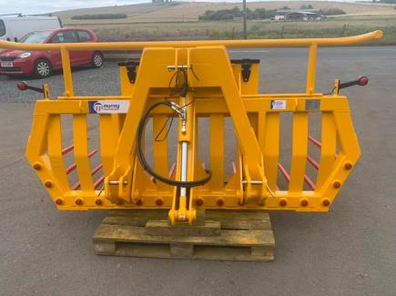 Hydraulic tipping stone fork with tool/weight box