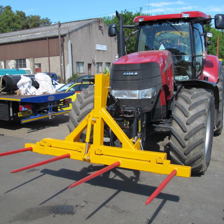 Hydraulically folding Front or Rear Bale Spike on the front linkage of a tractor.