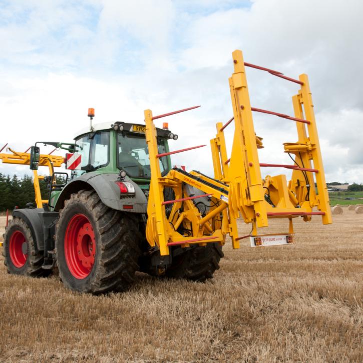 cta-Quad Bale Handling System - front and rear sections for carrying 12 round bales or 6 Heston bales at a time. Showing the hydraulic folding version.