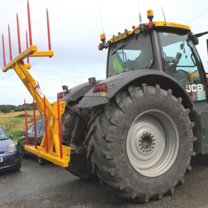 Hydraulically folding Big Bale Transporter for the back of tractors.