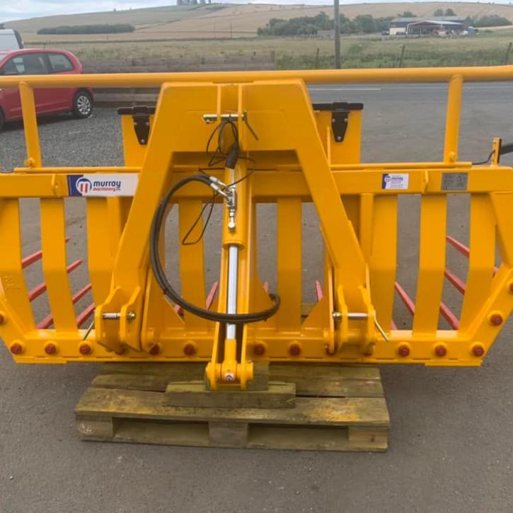 Hydraulic tipping stone fork with tool/weight box