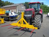 Hydraulically folding Front or Rear Bale Spike on the front linkage of a tractor.