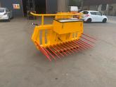 Hydraulic tipping stone fork with tool/weight box